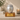 Silver Glow Metal Pet Ashes Urn on a memorial plinth with a brass plaque