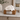 White Glossy Ceramic Sleeping Cat Pet Ashes Urn on a memorial plinth with a silver plaque